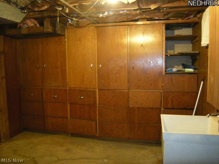 6651 Engle Road Cleveland, OH 44130 - Photo 11 of 20 Basement laundry area has built in storage for the extra soap cleaning supplies and paper goods.