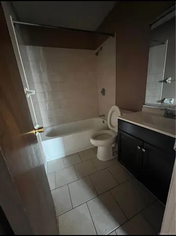 a bathroom with a granite countertop bathtub toilet and sink