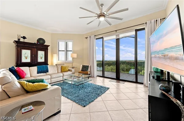 a living room with furniture and a floor to ceiling window
