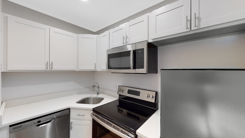a kitchen with stainless steel appliances a cabinets and a stove top oven