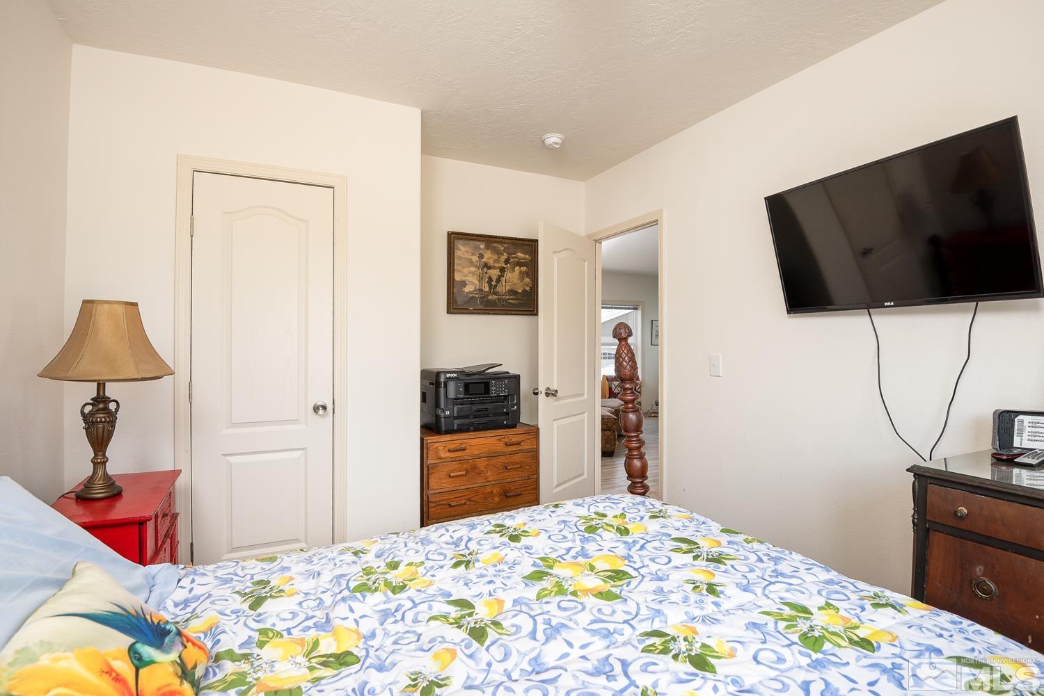 3904 Walker View Road Wellington, NV 89444 - Photo 19 of 37 a bedroom with a bed and a flat screen tv