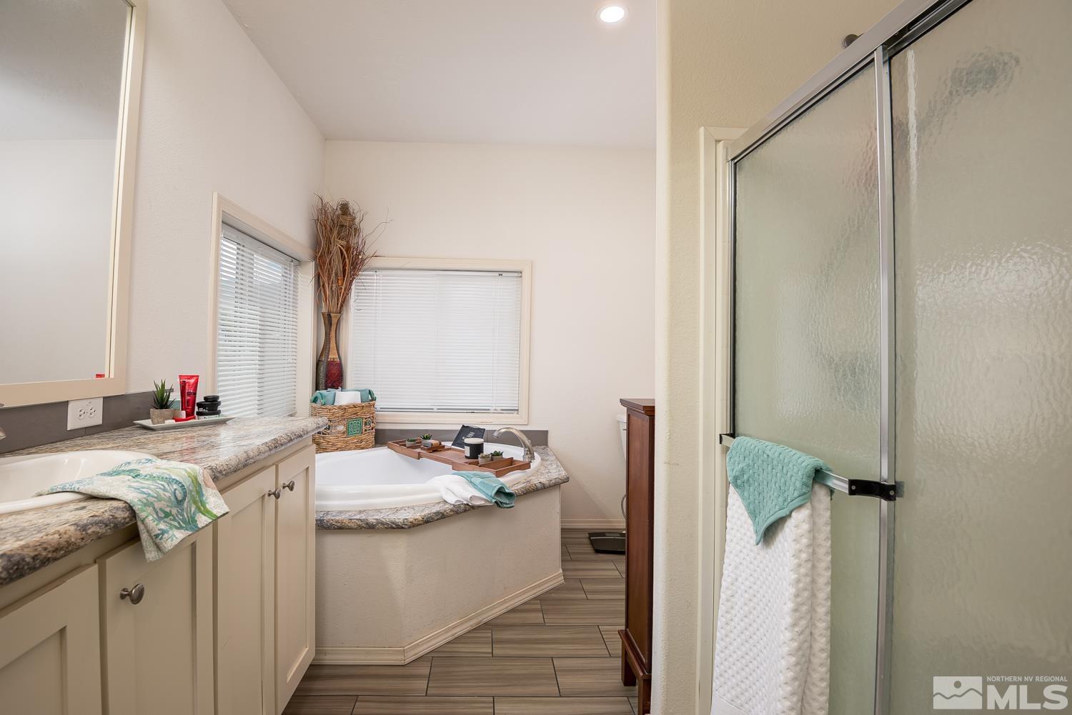 3904 Walker View Road Wellington, NV 89444 - Photo 23 of 37 a bathroom with a granite countertop sink and a mirror