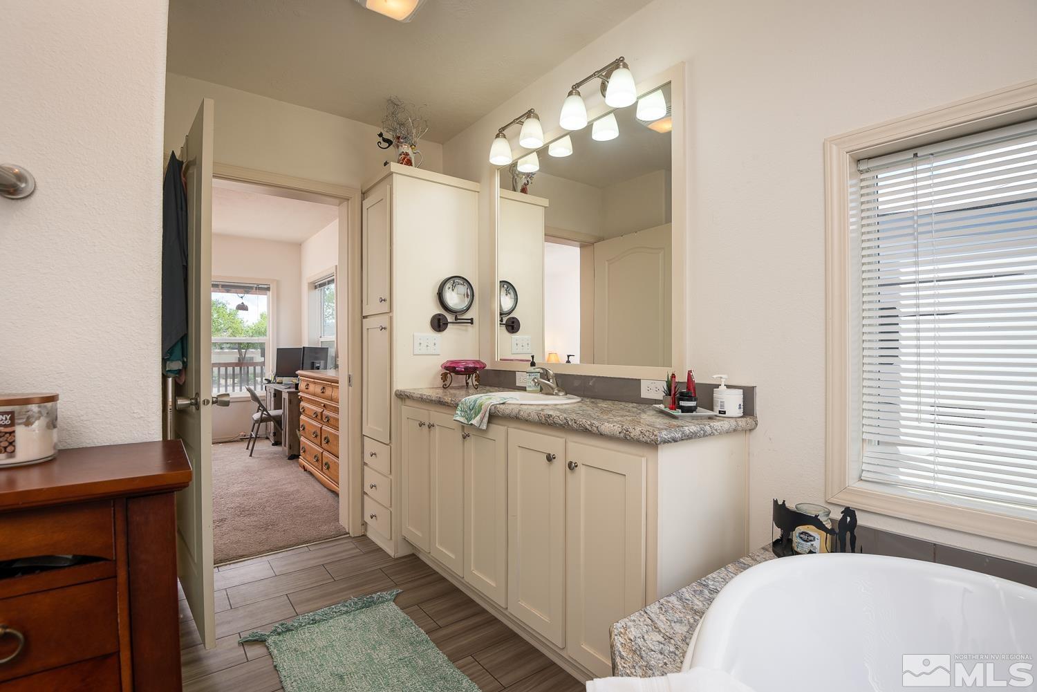 3904 Walker View Road Wellington, NV 89444 - Photo 24 of 37 a en suite bathroom with a granite countertop sink and a mirror
