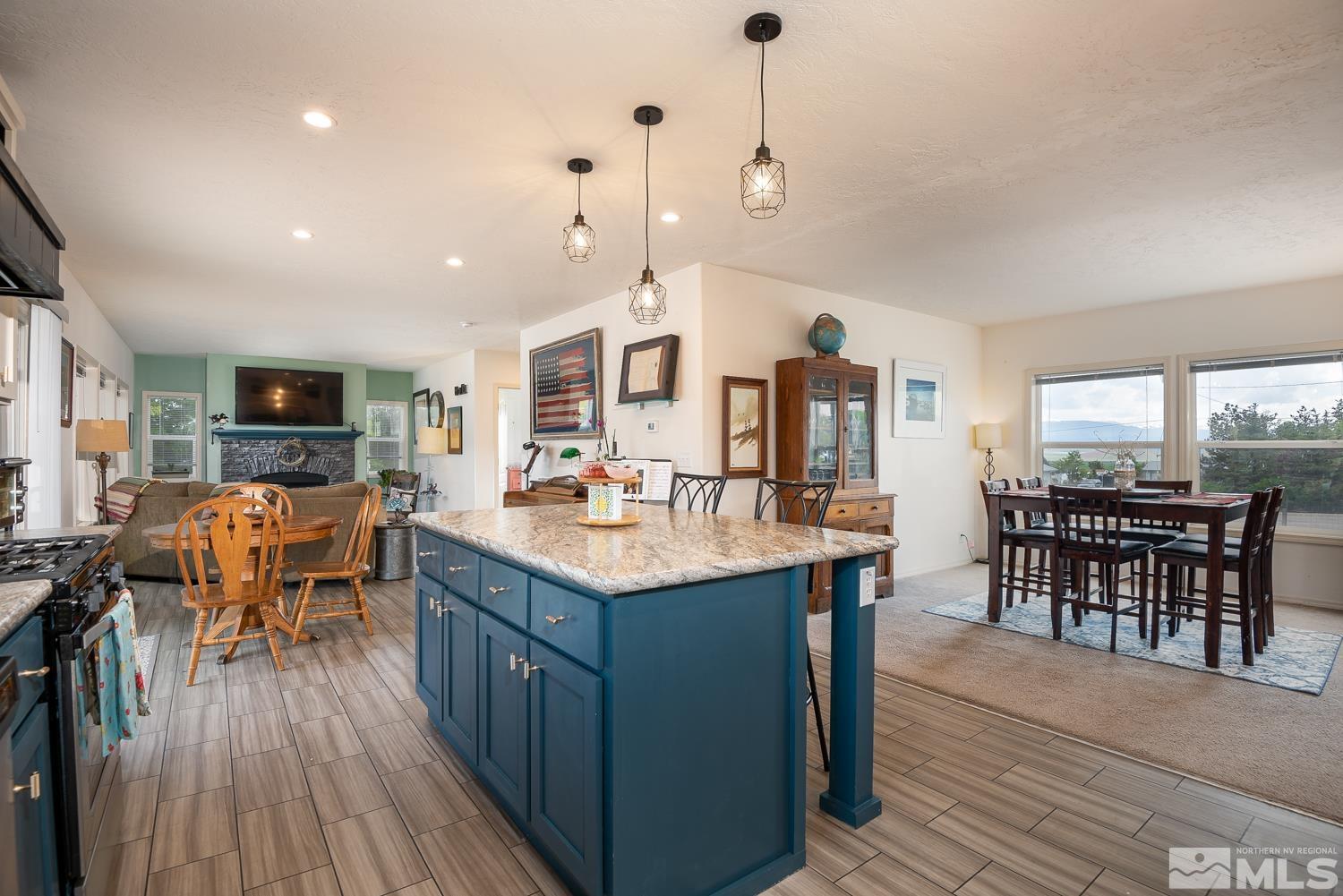 3904 Walker View Road Wellington, NV 89444 - Photo 5 of 37 a kitchen with stainless steel appliances kitchen island granite countertop a table chairs and a view of living room