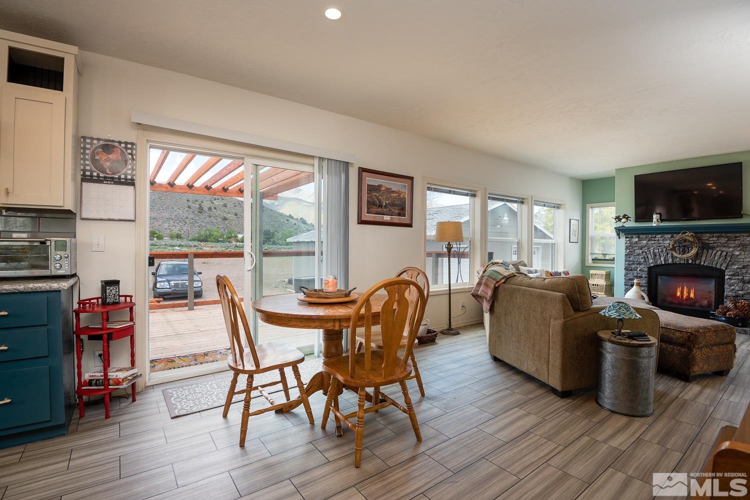 3904 Walker View Road Wellington, NV 89444 - Photo 8 of 37 a living room with furniture a fireplace and a flat screen tv