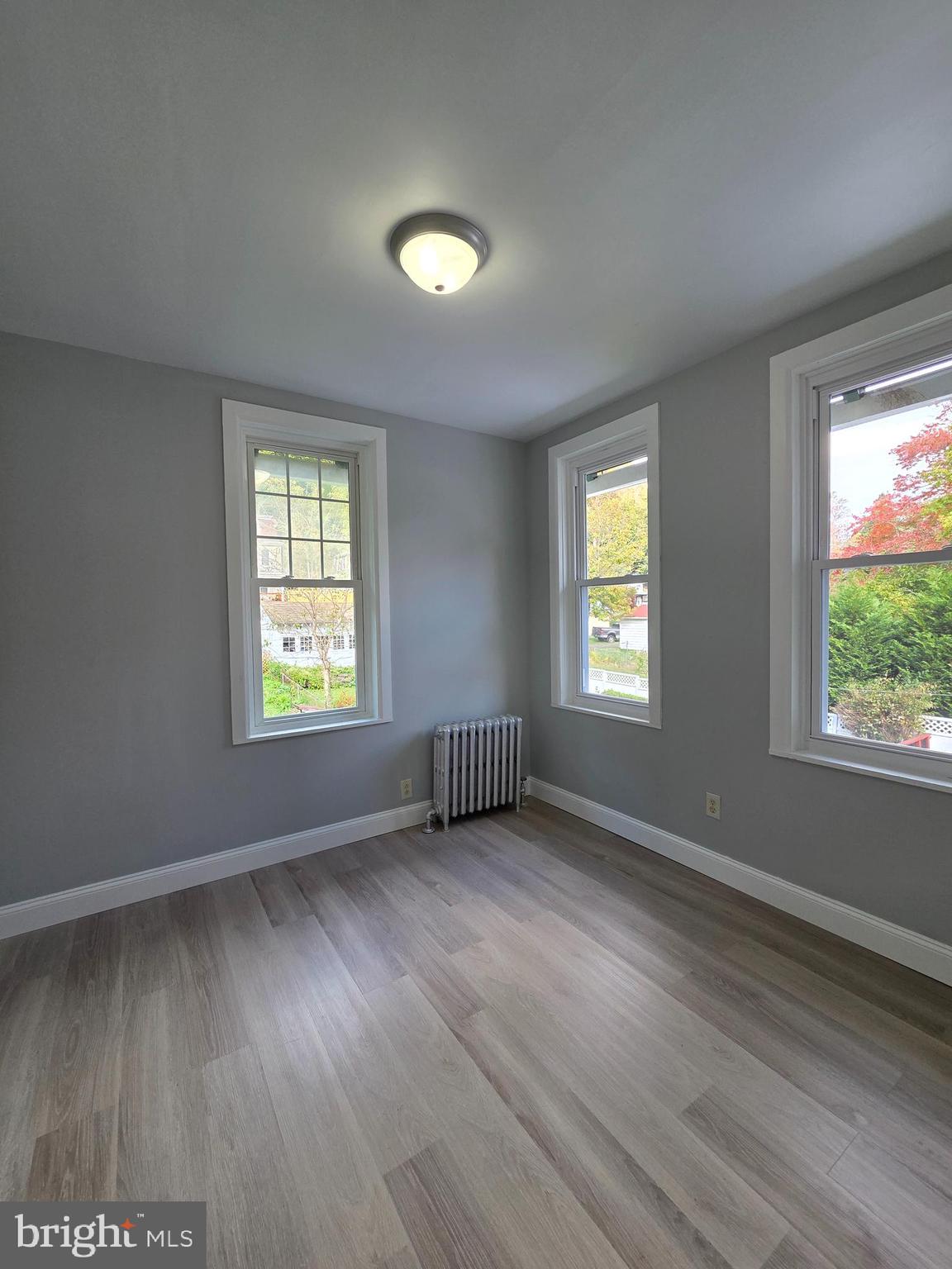 1440 Friedensburg Road Reading, PA 19606 - Photo 17 of 41 an empty room with wooden floor and windows