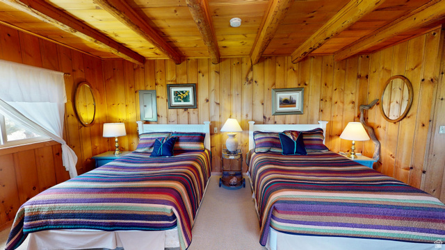 315 Abbey Road Moab, UT 84532 - Photo 10 of 46 Carpeted bedroom with electric panel, a wooden ceiling with exposed beams, and wooden walls