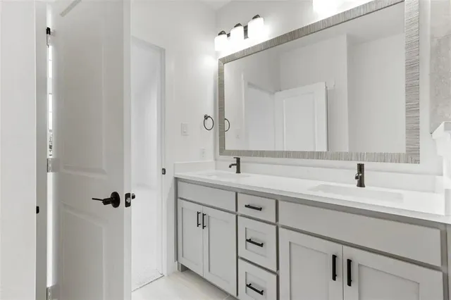 a bathroom with a sink double vanity and a mirror