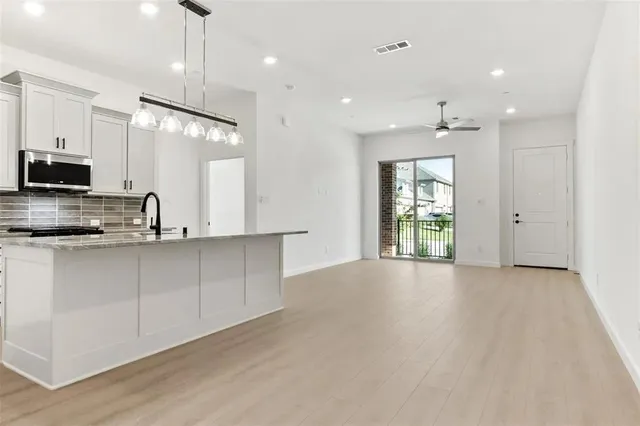 a view of a kitchen with a sink and a window