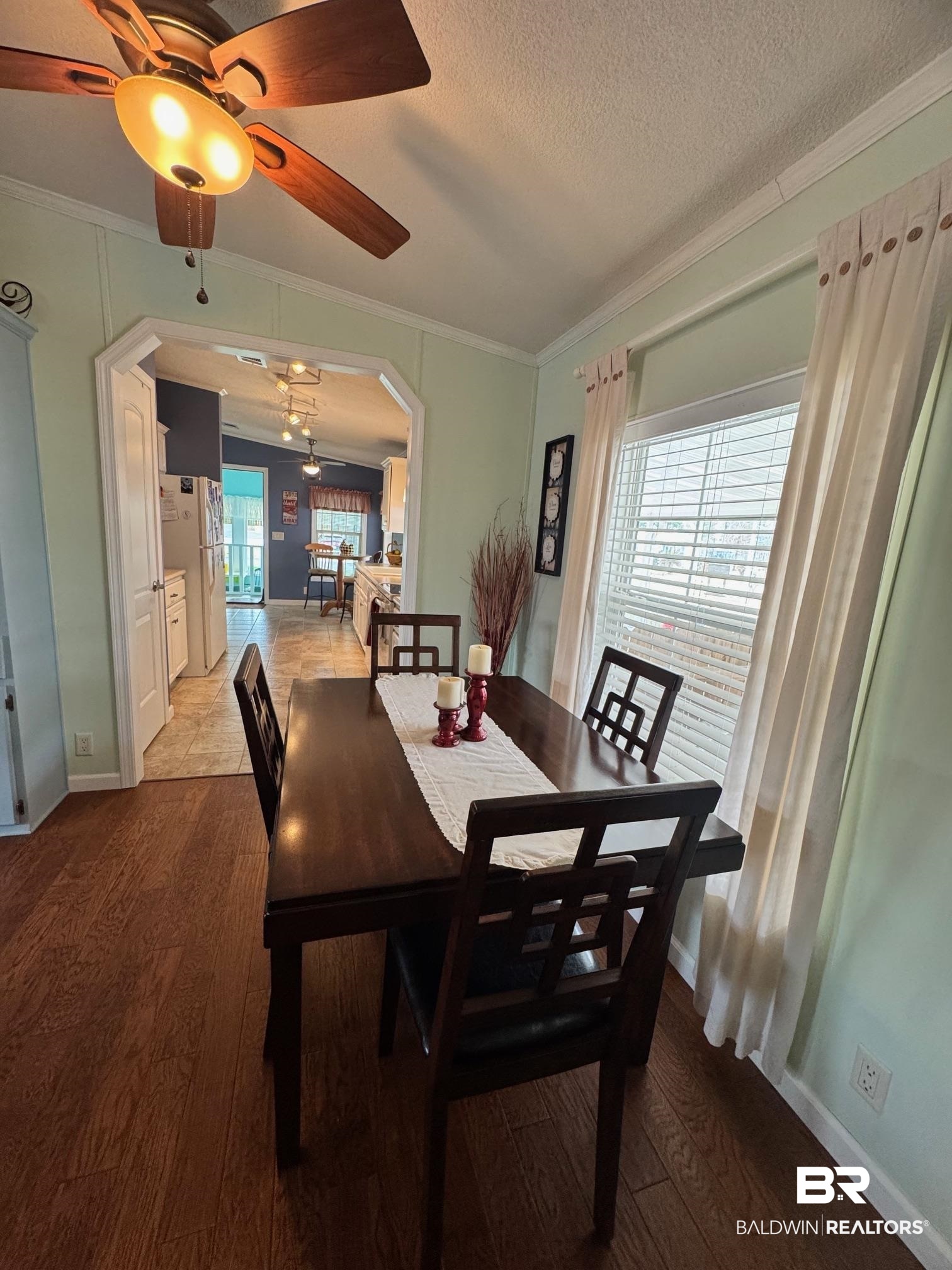 1165 Santa Anna Lane Lillian, AL 36549 - Photo 6 of 43 Dining area with ornamental molding, plenty of natural light, and wood finished floors