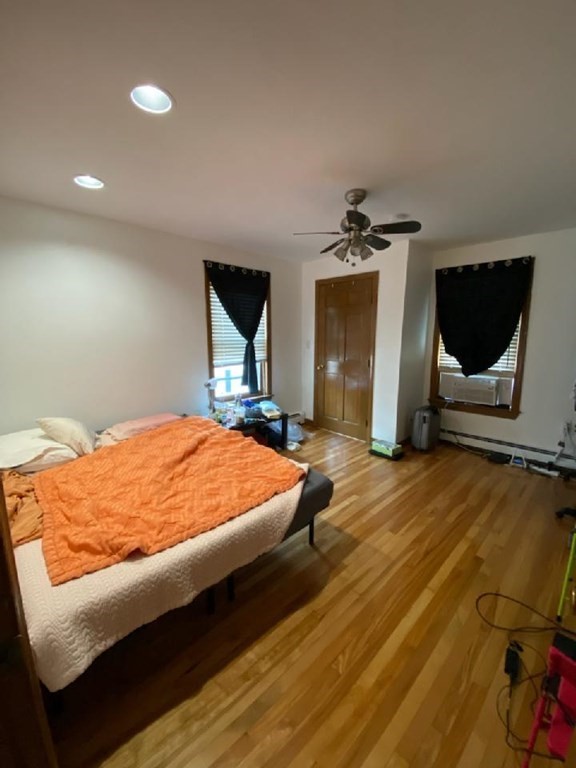 548 Pleasant Street, Unit 2R Worcester, MA 01602 - Photo 3 of 5 a bedroom with a bed and a television