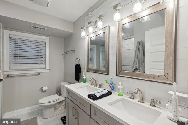 a bathroom with a toilet sink and mirror