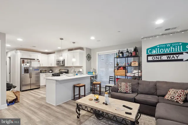 a living room with furniture and a kitchen view