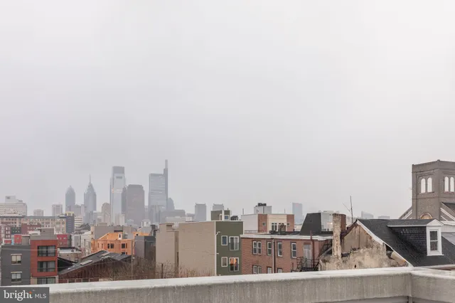 a living room with furniture a refrigerator and a couch