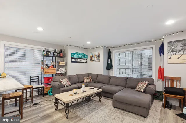 a living room with furniture and a book shelf