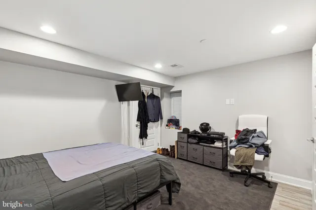 a large kitchen with kitchen island a sink stainless steel appliances and cabinets