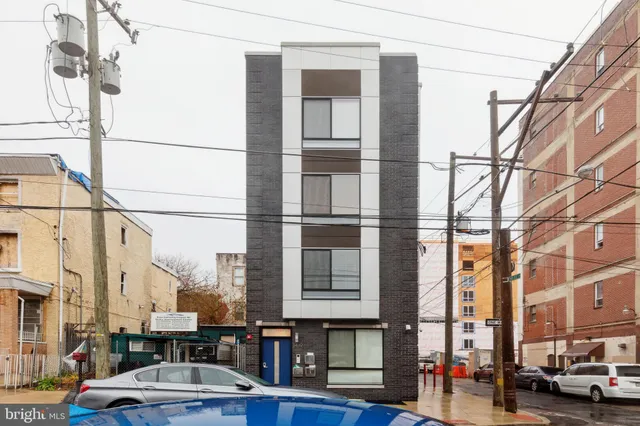 a kitchen with granite countertop a sink stainless steel appliances and cabinets