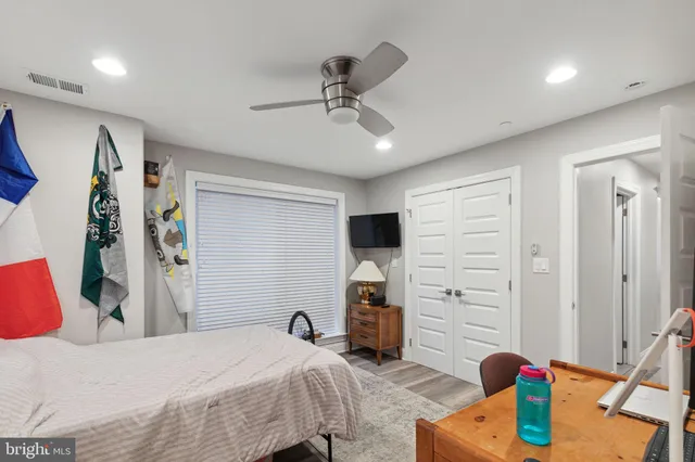 a bedroom that has a bed and a dresser