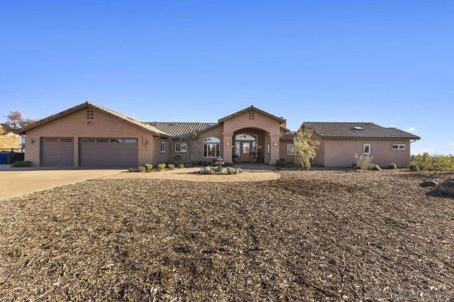 a living room with furniture a fireplace and a large window