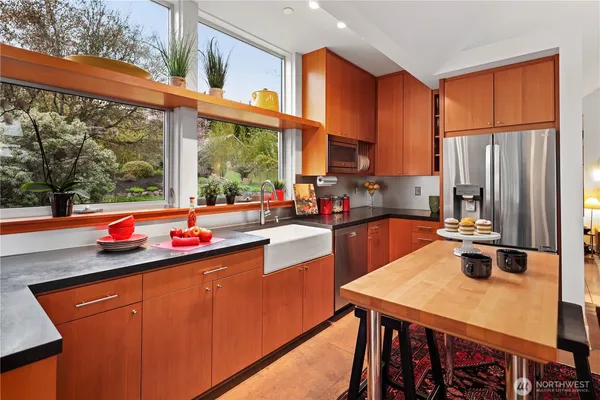 a kitchen with a sink a counter and chairs