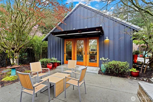 a backyard of a house with outdoor seating