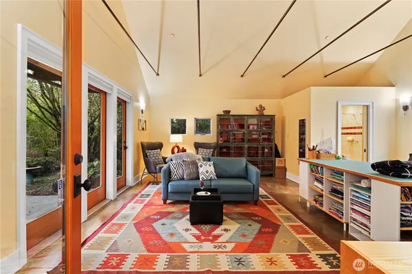 a living room with furniture wooden floor and a table