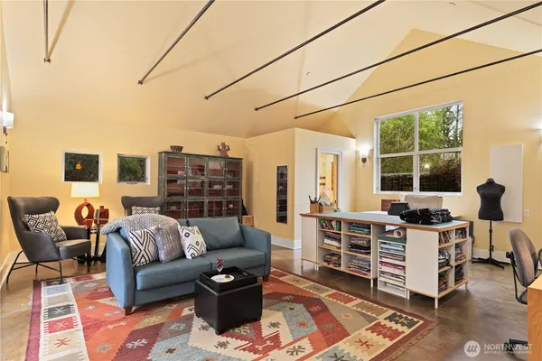 a living room with furniture a lamp and a table