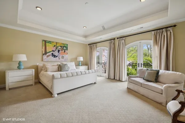 a bedroom with a bed and a chandelier