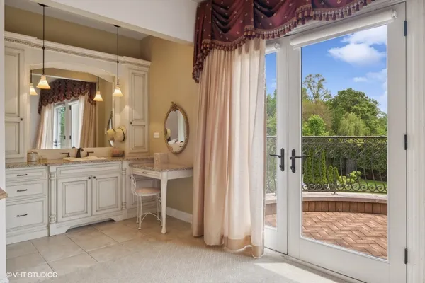 a bedroom with a bed mirror and a large window