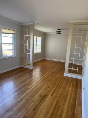a view of a room with wooden floor and a fireplace