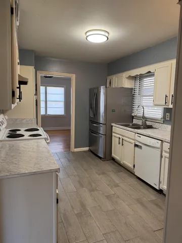 a kitchen with a sink stove and refrigerator