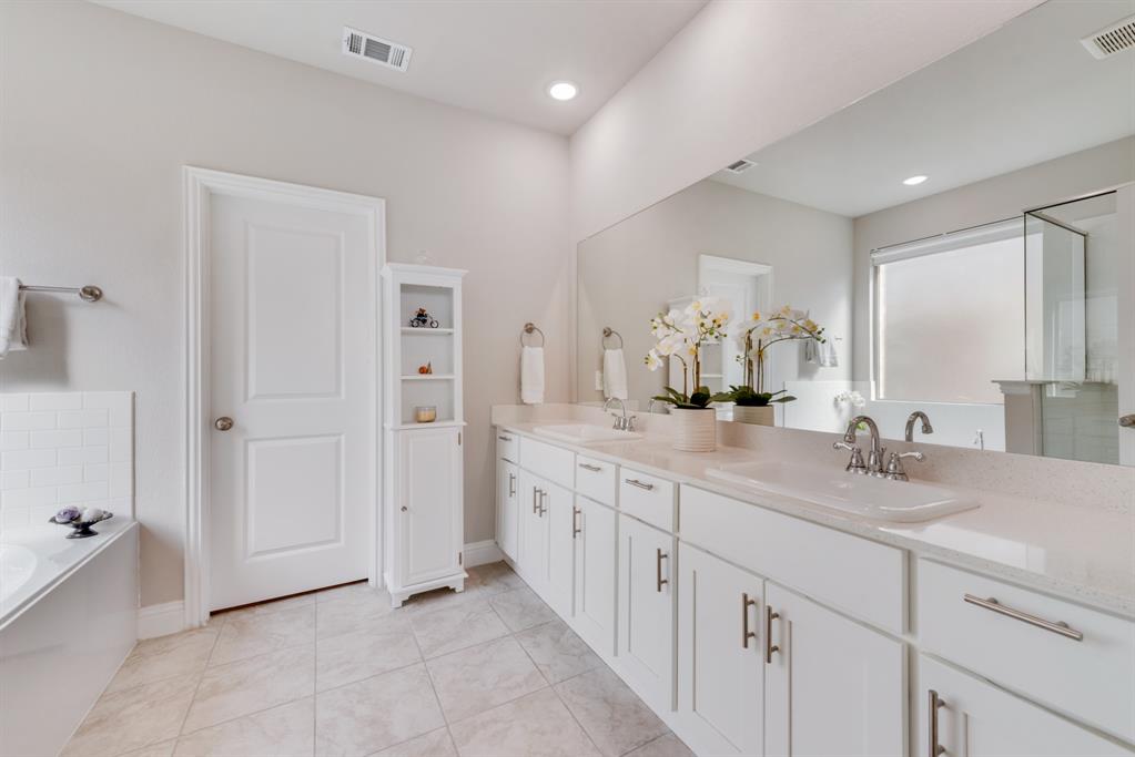 2301 Mount Olive Lane Forney, TX 75126 - Photo 13 of 36 a bathroom with double sink and a mirror
