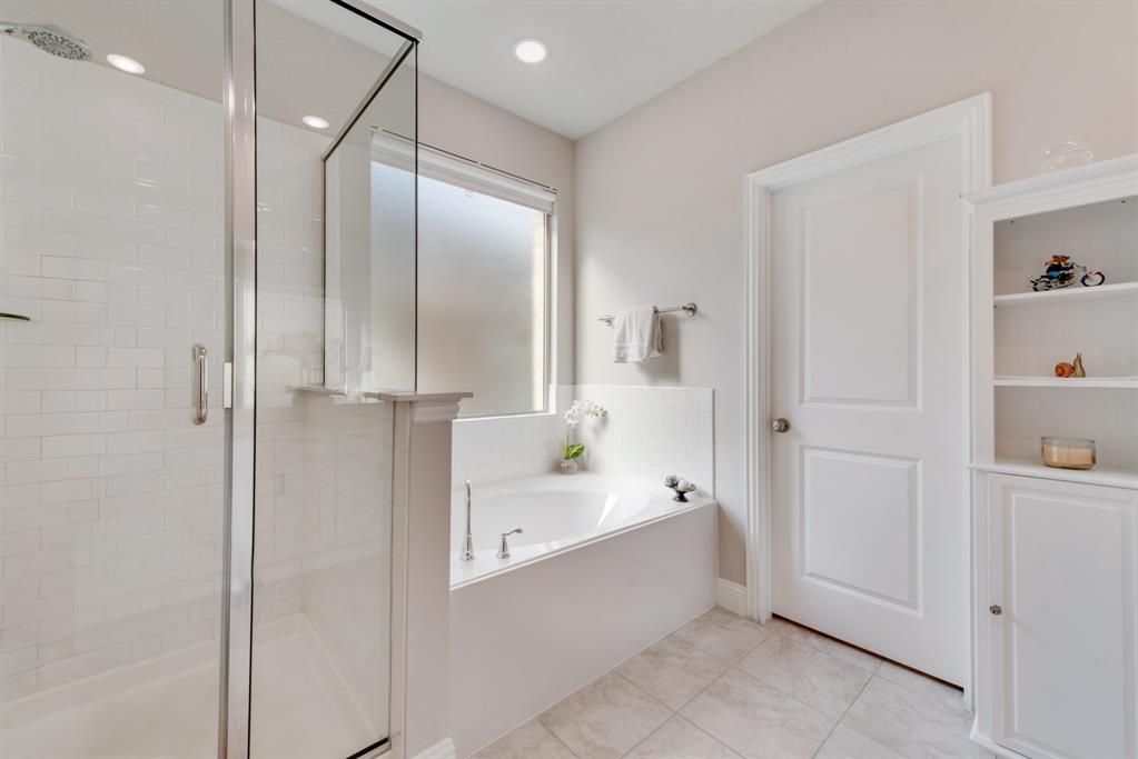 2301 Mount Olive Lane Forney, TX 75126 - Photo 14 of 36 a bathroom with a bathtub and a shower