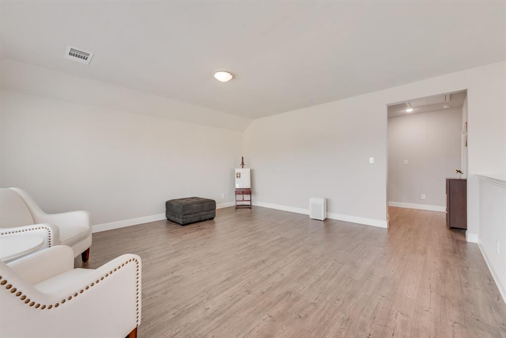 2301 Mount Olive Lane Forney, TX 75126 - Photo 17 of 36 a view of an empty room with wooden floor and a window