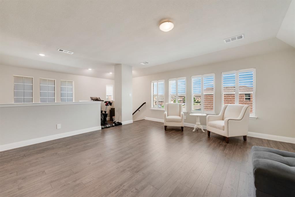 2301 Mount Olive Lane Forney, TX 75126 - Photo 19 of 36 a living room with furniture and a wooden floor