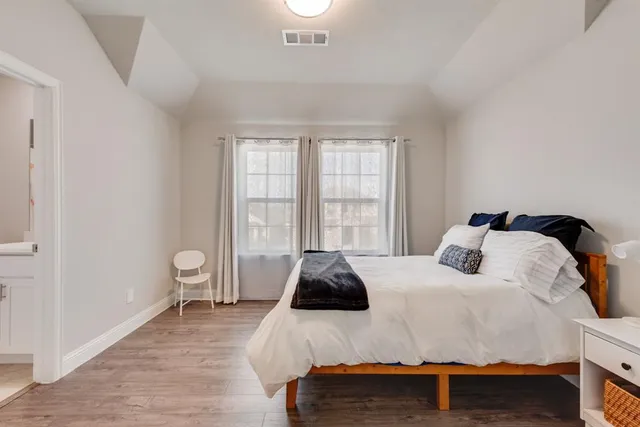 a bedroom with a bed and a window