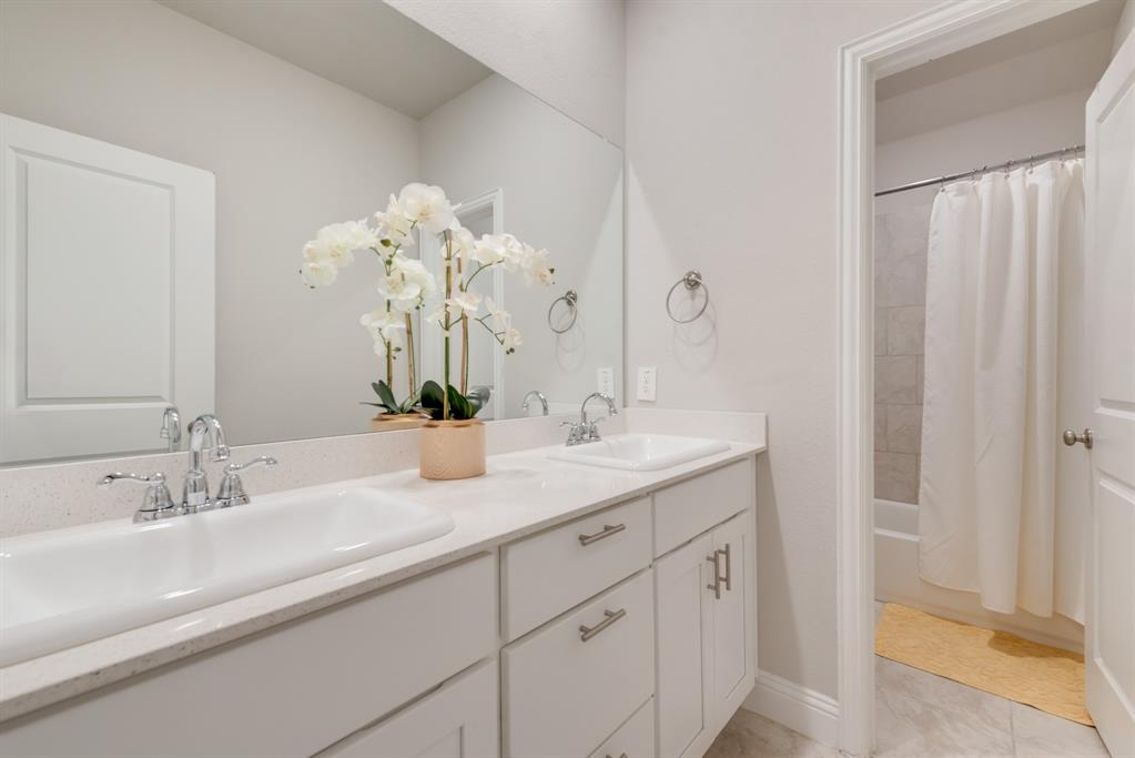 2301 Mount Olive Lane Forney, TX 75126 - Photo 23 of 36 a bathroom with a double vanity sink and a mirror