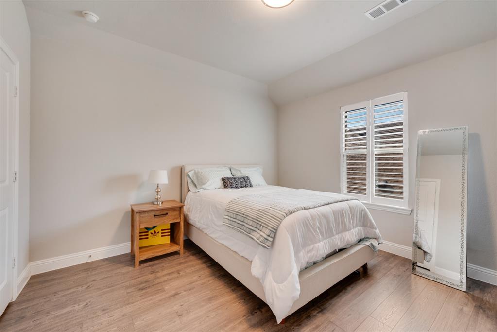 2301 Mount Olive Lane Forney, TX 75126 - Photo 24 of 36 a bed sitting in a bedroom next to a window