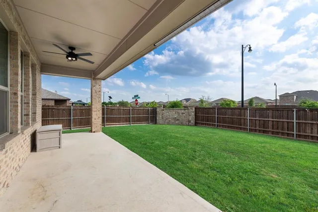 a view of a house with a yard and sitting area