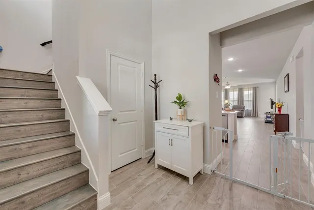a view of entryway and hall with wooden floor
