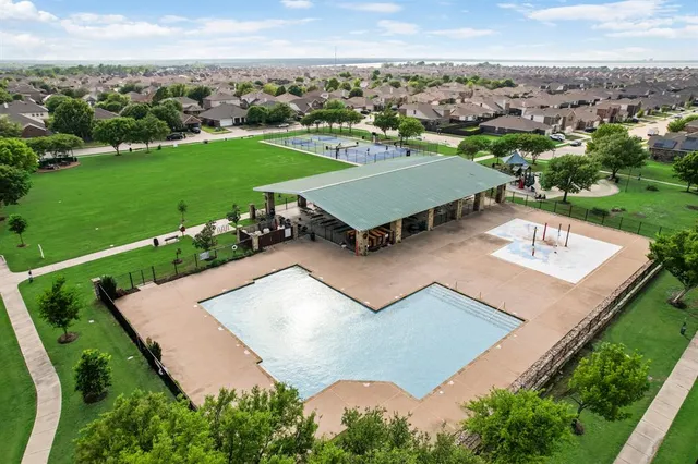 an aerial view of a house with garden space and ocean view