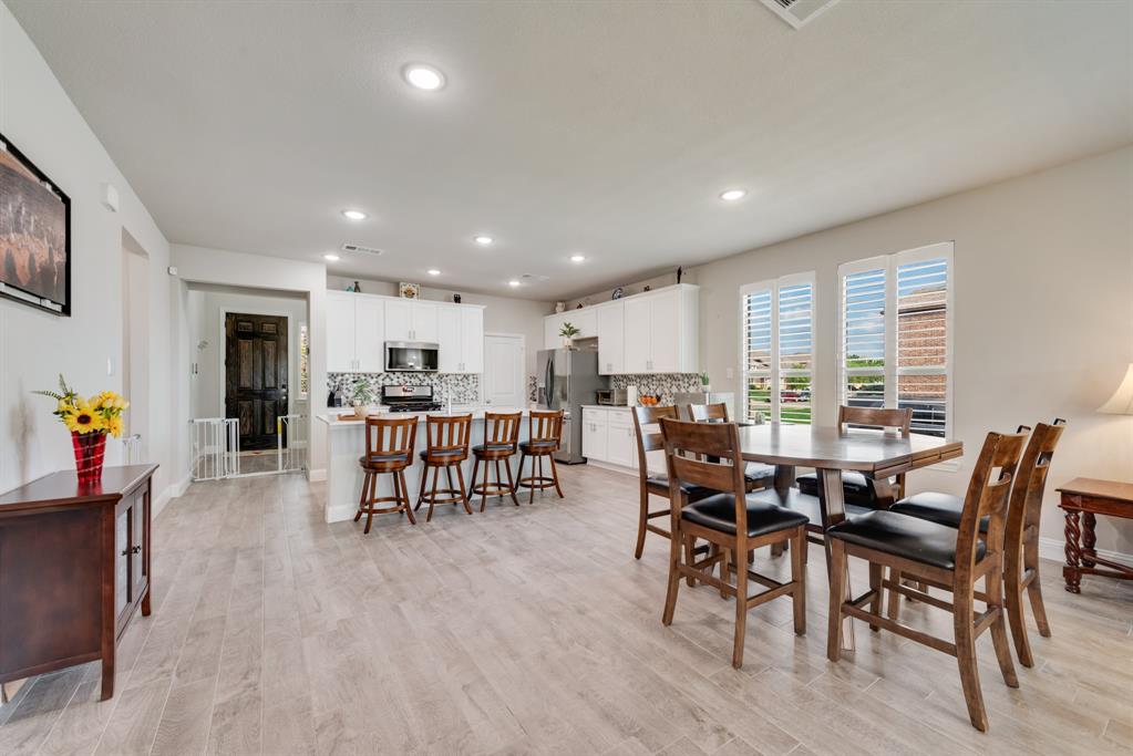 2301 Mount Olive Lane Forney, TX 75126 - Photo 6 of 36 a view of a dining room with furniture window and wooden floor