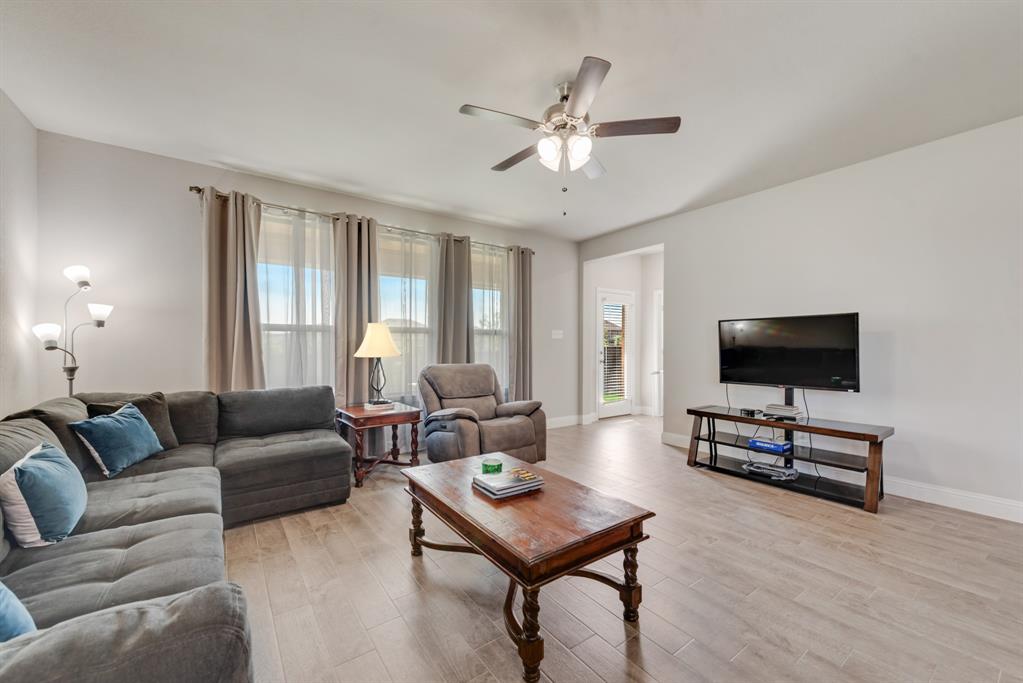 2301 Mount Olive Lane Forney, TX 75126 - Photo 10 of 36 a living room with furniture and a flat screen tv