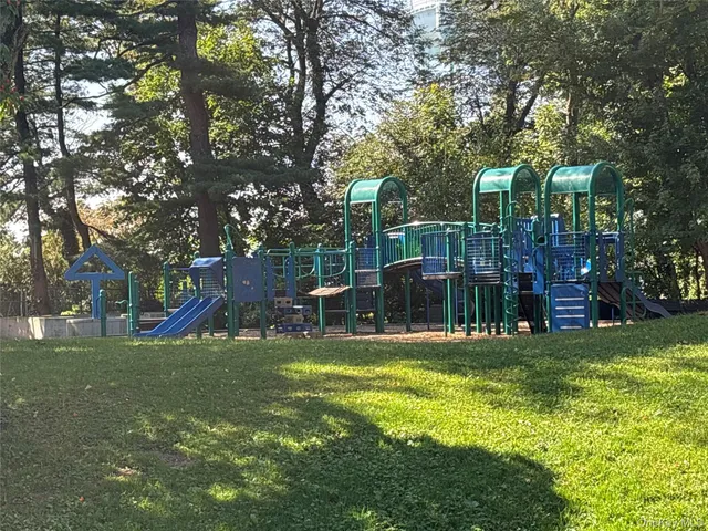 a view of a park with swings and slides