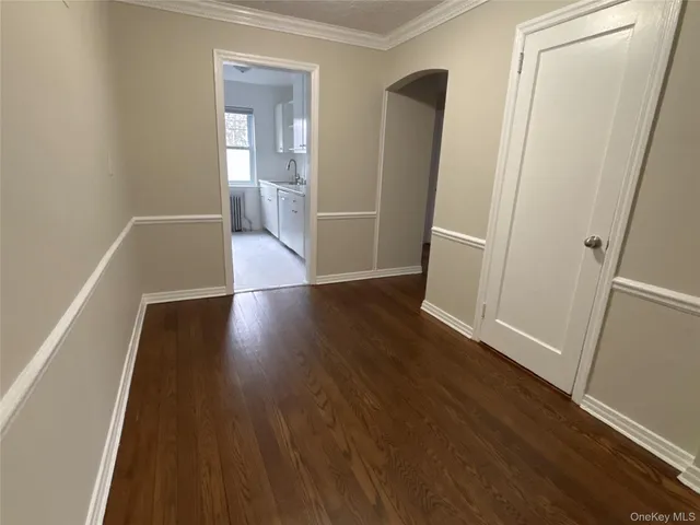 an empty room with wooden floor and closet