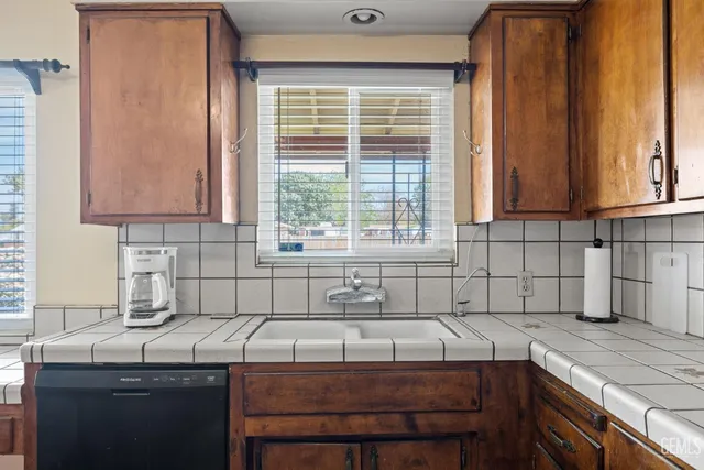 a kitchen with a sink cabinets and window
