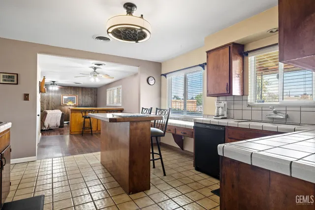 a kitchen with a sink a counter and dining area