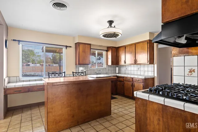 a kitchen with stainless steel appliances a sink stove and cabinets