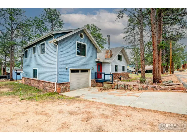 a view of a house with snow on the side of the road