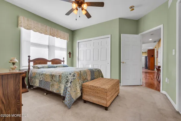 a bedroom with a bed couch and window